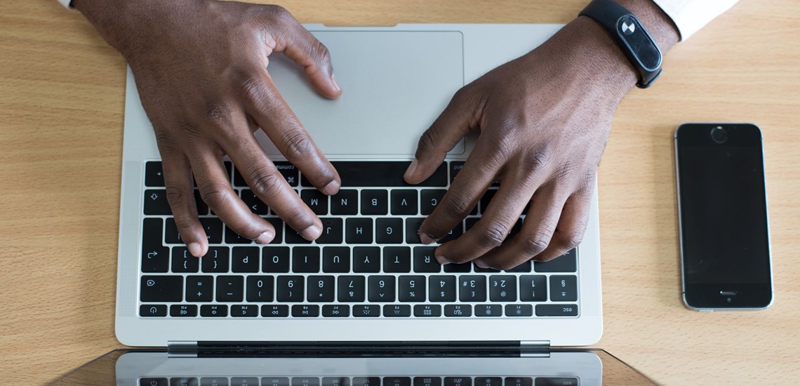 Man typing on keyboard