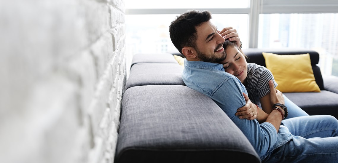 Man and woman sitting on a sofa