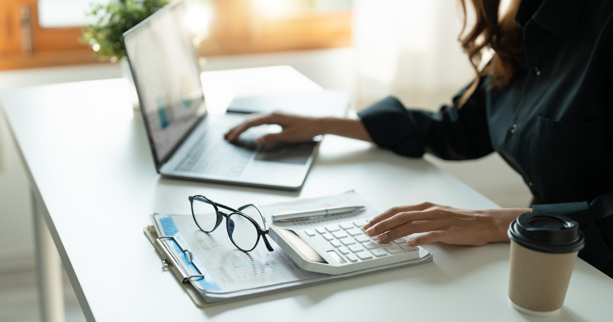 Self-Employed woman working on a laptop from her desk.
